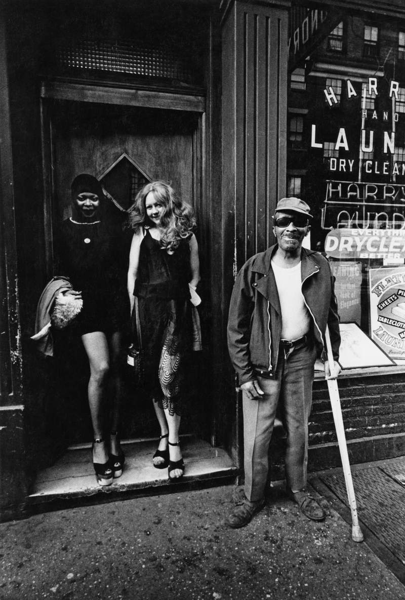 “Greenwich Village, when it was still Greenwich Village before the yuppies decimated it. Bleecker and Sullivan. I lived on Sullivan, and that was caddy-corner to me. Those were two girls out for the day, and then an old fellow who came from the Mills Hotel around the corner. It’s a wonderful moment.” 1978.